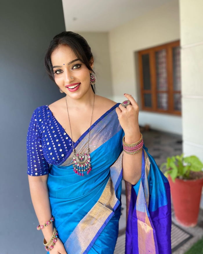 \"Explore the mesmerizing world of Malavika Menon through these stunning images. Get ready to be enchanted by her beauty and charm. Don't miss out on the latest trending sensation. #MalavikaMenon #SizzlingImages #BeautyUnleashed\"
