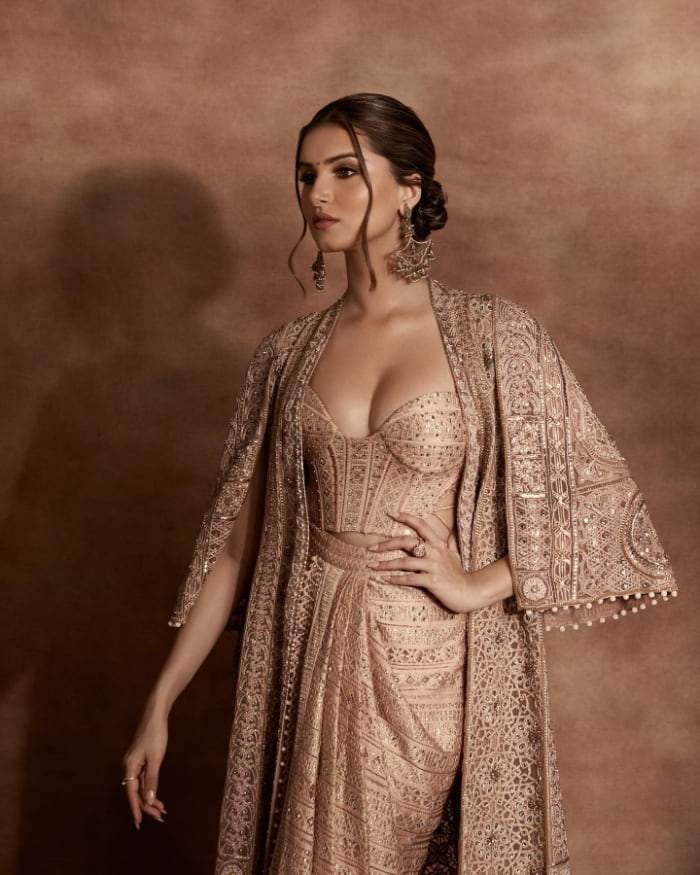 \"Discover the enchanting beauty of Bollywood sensation Tara Sutaria in these stunning photographs. Dive into the latest trend in glamour with Tara's charming stills. Don't miss out on this mesmerizing visual journey!  #TaraSutaria #BollywoodGlamour #CharmingStills #TrendingPhotographs\"